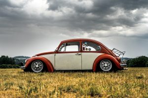 white and red Volkswagen Beetle hatchback