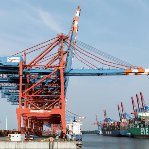 A large crane sitting next to a large ship